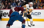 Penguins center Sidney Crosby passes the puck as Avalanche defenseman Jack Johnson pursues in the second period Wednesday