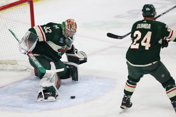 Minnesota Wild goaltender Filip Gustavsson (32) stops the puck during the first period of an NHL hockey game against the Boston Bruins, Sunday, March 
