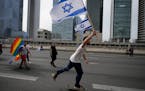 Israelis protest against plans by Prime Minister Benjamin Netanyahu’s government to overhaul the judicial system block the freeway in Tel Aviv, Isra