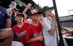 Fans vie for autographs before a spring training baseball game between the Atlanta Braves and the Philadelphia Phillies in North Port, Fla., Saturday,