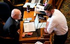 FILE - Iowa state Rep. Steven Holt, R-Denison, talks with House Majority Leader Matt Windschitl, right, in the Iowa House Chambers, May 23, 2022, at t