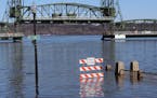 A walkway is under water along the St. Croix River during spring flooding Tuesday March 31, 2020, in downtown Stillwater, Minn.