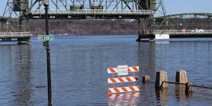 A walkway is under water along the St. Croix River during spring flooding Tuesday March 31, 2020, in downtown Stillwater, Minn.