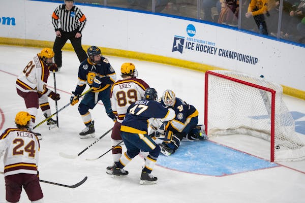 Forward Jimmy Snuggerud (81) scored on Canisius goaltender Jacob Barczewski, one of six third-period goals for the Gophers to break open their NCAA me