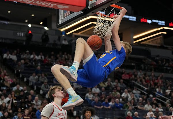 Wayzata guard Jackson McAndrew dunked in the second half of the Trojans’ 79-77 victory over Lakeville North in the Class 4A boys basketball semifina