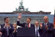 In this June 12, 1987 file photo U.S. President Reagan acknowledges the crowd after his speech in front of the Brandenburg Gate in West Berlin, where 