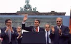 In this June 12, 1987 file photo U.S. President Reagan acknowledges the crowd after his speech in front of the Brandenburg Gate in West Berlin, where 