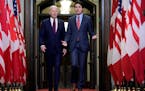 President Joe Biden walks with Canadian Prime Minister Justin Trudeau during an arrival ceremony at Parliament Hill, Friday, March 24, 2023, in Ottawa