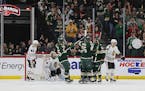 Wild right wing Ryan Reaves (75) celebrated with teammates after scoring a goal against the Chicago Blackhawks during the second period.