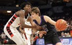 Albany’s Tysen Gerads was fouled by Harrison Aligbe while driving the baseline in the second half Saturday. Gerads scored 19 points for the Huskies.