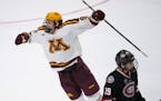 Minnesota Gophers forward Matthew Knies (89) leapt to celebrate teammate Jaxon Nelson’s empty net goal late in the third period as his former teamma
