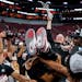 After cutting down a net, San Diego State coach Brian Dutcher fell back into the arms of his players after the Aztecs beat Creighton 57-56 in the Sout