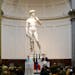 German Chancellor Angela Merkel, left, and Italian Prime Minister Matteo Renzi speak during a press conference in front of Michelangelo’s “David s