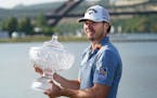 Sam Burns held his trophy after defeating Cameron Young in the final match at the WGC-Dell Technologies Match Play Championship golf tournament in Aus