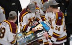Minnesota Gophers defenseman Brock Faber (14) put the Gophers logo on their ticked to Tampa after their win over the Huskies. The University of Minnes