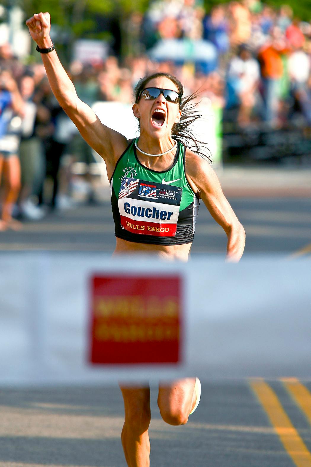 Kara Goucher raised her fist in celebration as she approached the finish line of the U.S. Half Marathon Championship on June 16, 2012, in Canal Park in Duluth.