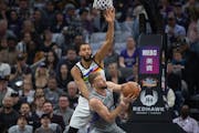 Kings forward Domantas Sabonis was defended by Wolves center Rudy Gobert in the first quarter Monday night.