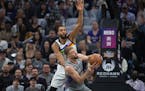 Kings forward Domantas Sabonis was defended by Wolves center Rudy Gobert in the first quarter Monday night.