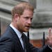 Britain’s Prince Harry waves to the media as he arrives at the Royal Courts Of Justice in London, Tuesday, March 28, 2023. Prince Harry is in a Lond
