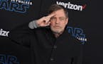 Mark Hamill salutes as he arrives at the world premiere of “Star Wars: The Rise of Skywalker” in Los Angeles on Dec. 16, 2019. 
