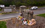 A make shift memorial is seen at the entry to Covenant School with a police car guarding, on Tuesday, March 28, 2023, in Nashville.