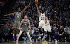 Mike Conley of the Wolves shot over Sacramento’s Harrison Barnes on Monday night. 