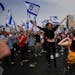 Demonstrators block a highway on March 23 in Tel Aviv during protest against plans by Prime Minister Benjamin Netanyahu’s government to overhaul the