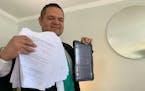Minneapolis City Council candidate Victor Martinez showed paper forms for delegates and other information on a tablet inside his home Tuesday. The Min