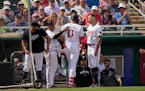 Minnesota Twins Joey Gallo (13) is greeted at the dugout after hitting a solo homer in the second inning of a spring training baseball game against th