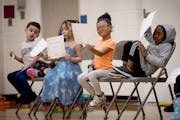 Student of the month winners check out their certificates during a school awards assembly at Nellie Stone Johnson Elementary School in Minneapolis.
