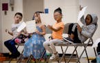 Winners of student of the month awards check out their certificates during a school assembly at Nellie Stone Johnson Elementary School in Minneapolis,