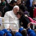 Pope Francis hugs a child at the end of his weekly general audience in St. Peter’s Square, at the Vatican, Wednesday, March 29, 2023.