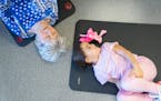 Pat Solstad and Isabella Calderon, 5, rock their knees during an intergenerational yoga class Wednesday, March 29, 2023 at the Woodbury YMCA in Woodbu