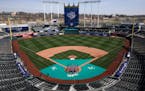 Members of the Kansas City Royals’ grounds crew work off the field in preparation for the 2023 baseball season Wednesday, March 29, 2023, at Kauffma