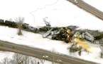 In this photo provided by KSTP, emergency personnel respond to the scene of a train derailment early Thursday, March 30, 2023 in Raymond, Minn. A trai