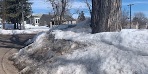 Snow is piled nearly 6 feet high on a West Duluth neighborhood corner.