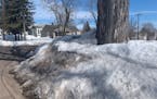 Snow is piled nearly 6 feet high on a corner in a West Duluth neighborhood. 
