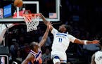 Timberwolves center Naz Reid (11) missed a dunk as Phoenix center Bismack Biyombo (18) defended Wednesday. Reid fell to the court and fractured his wr