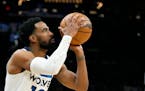 Minnesota Timberwolves guard Mike Conley gets ready to shoot a jumper against the Phoenix Suns during the first half of an NBA basketball game Wednesd