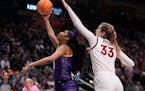 LSU’s Angel Reese shoots past Virginia Tech’s Elizabeth Kitley during the second half of Friday’s Women’s Final Four semifinals 