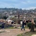 People surveyed storm damage in the Walnut Vallery area of west Little Rock, Ark., Friday, March 31, 2023.