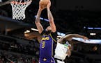 Lakers forward Anthony Davis dunks the ball against the Timberwolves in the fourth quarter Friday.