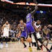 Timberwolves guard Anthony Edwards loses the ball as he collides with Lakers forward Wenyen Gabriel in the first quarter Friday