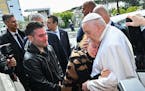 Pope Francis hugged Serena Subania as her husband Matteo Rugghia, left, reacts — the couple had lost their five-year-old child a day earlier — as 