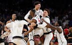 San Diego State guard Lamont Butler (5) celebrates with teammates after scoring the winning basket against Florida Atlantic during the Final Four semi