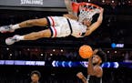 Connecticut guard Andre Jackson Jr. dunks the ball over Miami forward Norchad Omier during the second half 