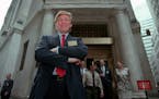 Donald Trump poses for photos outside the New York Stock Exchange after the listing of his stock on June 7, 1995, in New York. 