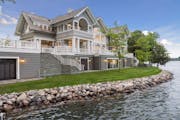The East Coast shingle-style house on Lake Minnetonka sits on a private peninsula with an expansive shoreline and a nearly 3-acre “parklike” setti