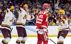 Gophers defenseman Mike Koster, right, celebrated after scoring in the Frozen Four semifinals against Boston University on April 6 in Tampa, Fla. He w