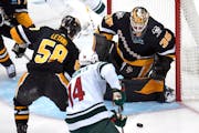 Penguins goalie Tristan Jarry blocked a shot by Joel Eriksson Ek of the Wild on Thursday. Eriksson Ek left the game later because of an injury.